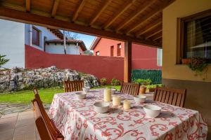a table with a red and white table cloth at Casa rural playa nves002r in Naves