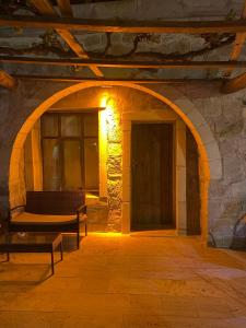 an archway in a stone building with a door at Seven Rock Cave Hotel in Göreme +31 photos