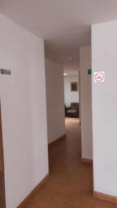 a hallway with white walls and a no smoking sign at Aguascalientes feria nacional de San Marcos in Aguascalientes