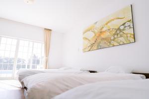 Postel nebo postele na pokoji v ubytování Hotel Kailani