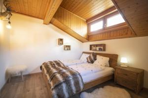 a bedroom with a bed and a wooden ceiling at Meis Chalet in Scuol