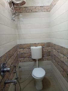 a bathroom with a toilet and a bath tub at Swastik Guest House Inn Varanasi in Varanasi