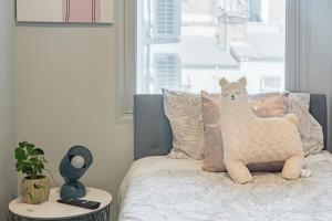 a bed with a stuffed llama pillow on it at Sydney CBD Near Train UTS DarlingHar&ICC&Chinatown - ROOM ONLY in Sydney