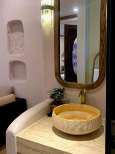 a sink in a bathroom with a mirror at The General's House in Hanoi