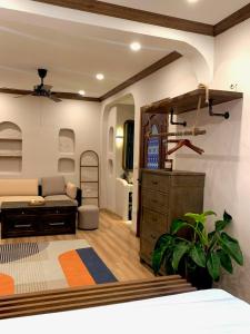 a bedroom with a bed and a dresser and a couch at The General's House - Entire private home in Hanoi +20 photos