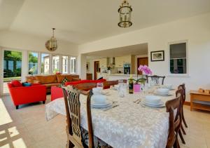 a dining room and living room with a table and chairs at Dentford Heights in Beetley