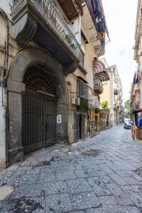 an alley with a large entrance to a building at Orto Botanico Family Flat by Wonderful Italy in Naples