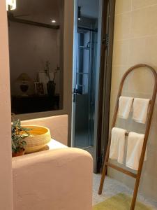 a bathroom with a towel rack and a mirror at The General's House in Hanoi