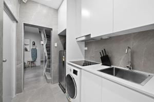 a kitchen with a sink and a washing machine at Private Double Bed in Sydney CBD Near Train in Sydney