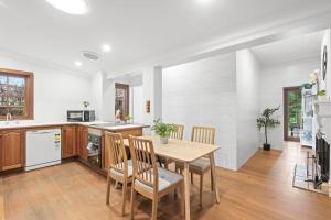 a kitchen and dining room with a table and chairs at Quadruple Room in Gordon near Train & Bus Sleeps 4 in Pymble
