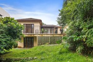 a large house with a balcony and a yard at Quadruple Room in Gordon near Train & Bus Sleeps 4 in Pymble