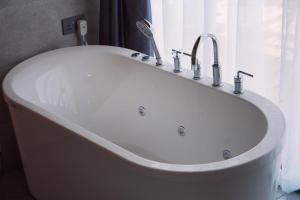 a white bath tub with a sink and a window at THE ARK PARADIO LODGE in Naivasha