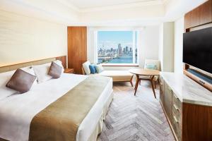 a hotel room with a large bed and a large window at InterContinental Tokyo Bay by IHG in Tokyo