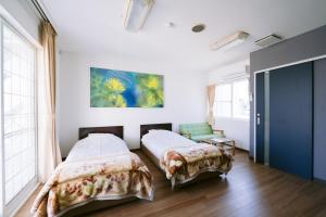 Postel nebo postele na pokoji v ubytování Hotel Kailani