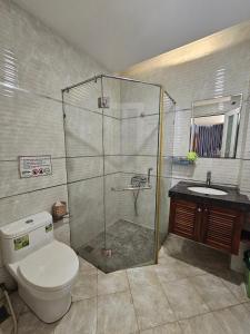 a bathroom with a shower and a toilet and a sink at ABC HOTEL BÌNH TÂN in Ho Chi Minh City +35 photos