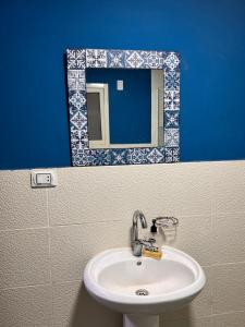 a bathroom with a sink and a mirror at Sphinx and Pyramids INN in Cairo