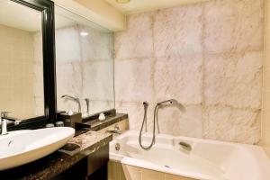 a bathroom with a sink and a tub and a mirror at InterContinental Tokyo Bay by IHG in Tokyo
