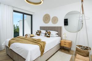 a white bedroom with a bed and a mirror at Gallery Luxury Suites & Rooms-Only Adults in Split