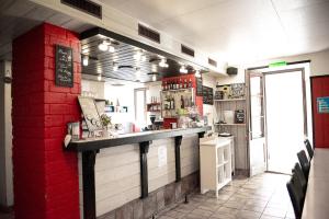 a kitchen with a counter and a red brick wall at Auberge du Mont Blanc in Trient