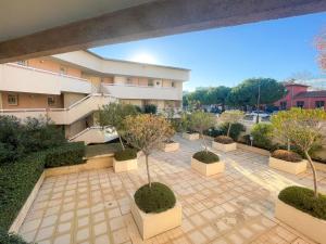 anterior view of a courtyard with trees and a building at Port Vauban Sea Front 3 Pers AC WiFi in Antibes