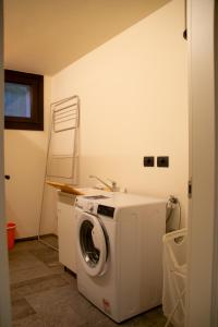 a washing machine in a room with a sink at Casa Cassiopea - WelcHome in Cannobio