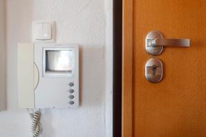 a door with a phone on a wall at Beach House Cascais in Estoril