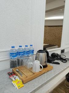 a tray with bottles of water on a counter at Efzen hotel in Istanbul