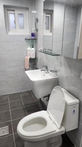 a bathroom with a white toilet and a sink at 2room with 4beds near kintex daehwa station in Goyang