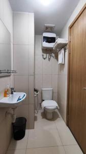 a small bathroom with a toilet and a sink at San Shang Ye - 2BR Baloi Apartment in Nagoya