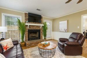 a living room with a couch and a fireplace at Alabama Get Away Gorgeous Home Location A Near Medical Ctr in Tuscaloosa