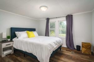 a bedroom with a large bed with a window at The Lucky Charm Home of the Fighting Irish! BBQ Outdoor Games Coffee in South Bend