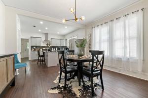 a kitchen and dining room with a table and chairs at Modern Escape in Historic District in Mobile +14 photos