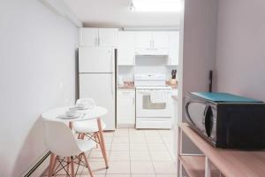 a small kitchen with a microwave and a small table at NEW Renovated Cozy 2 Br in Uptown Saint John Location Coffee in Saint John