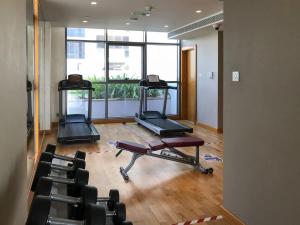 a gym with two exercise bikes and a large window at Frank Porter - DAMAC Hills Jasmine in Dubai