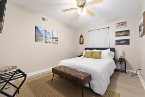 a white bedroom with a bed and a ceiling fan at The Ranch 4-Bedrooms Large Yard & Patio in Mobile
