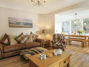 a living room with a couch and a table at Waterside - Luxury Menai Bridge Holiday Home - 4 Bed 4 Bath in Menai Bridge