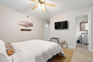 a bedroom with a bed and a ceiling fan at The Ranch 4-Bedrooms Large Yard & Patio in Mobile