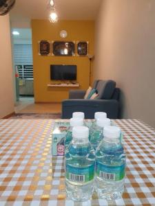 a group of water bottles sitting on a table at D' Permata Homestay Kulim in Kulim