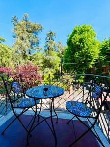 a table and chairs on a balcony with a table at Sant'Orsola Lodge Bologna in Bologna