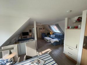 a living room with a blue couch and a living room at Ferienwohnung im Schafhaus in Wangerland