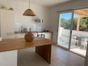 a kitchen with a table with a vase on it at Acqua di Mare in Torre Specchia Ruggeri