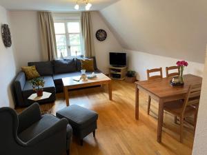 a living room with a couch and a table at Ferienhof Kotthoff am Hennesee in Meschede