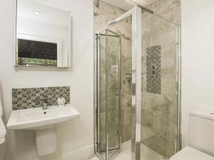 a bathroom with a shower and a sink at Waterside - Luxury Menai Bridge Holiday Home - 4 Bed 4 Bath in Menai Bridge