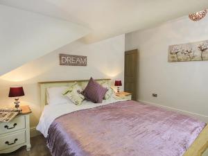a bedroom with a bed and a sign on the wall at Waterside - Luxury Menai Bridge Holiday Home - 4 Bed 4 Bath in Menai Bridge