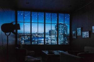 a room with a window with a view of a city at Hotel Gotham in Manchester