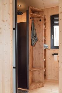 a wooden door in a room with a closet at Luxus-Hausboot DIVA mit Kamin in Hamburg