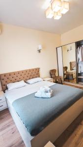 a bedroom with a large bed with a blue blanket at GG ApartHotel in Batumi