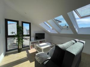 a living room with a couch and some windows at Apartamentos Ares Rentals in Ares