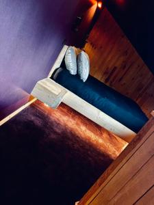 a bed with two white shoes on top of it at Blackroom in Theux