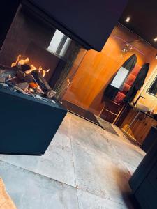 a kitchen with a stove with a fire in it at Blackroom in Theux